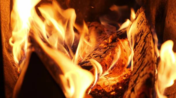 istock Close-up burning firewood in a brick fireplace. 1249746076