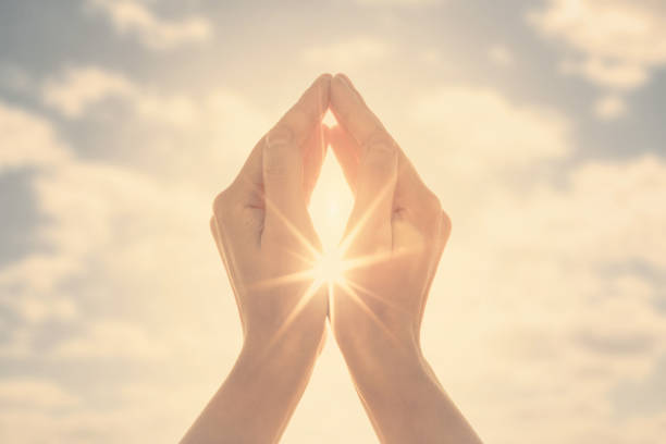 istock Woman hands holding the sun at dawn 1249747494