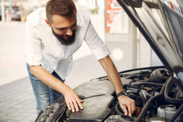 istock Handsome man checks the engine in his car 1249747534