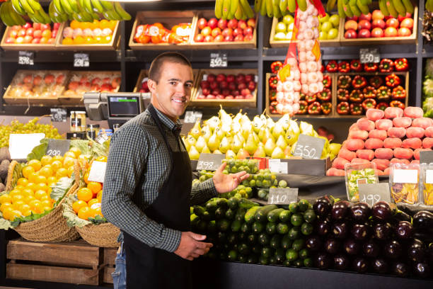 istock male  offering fresh vegetables and fruits 1249747577