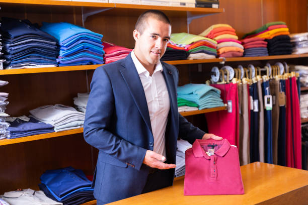 istock Salesman offering polo shirt 1249747996