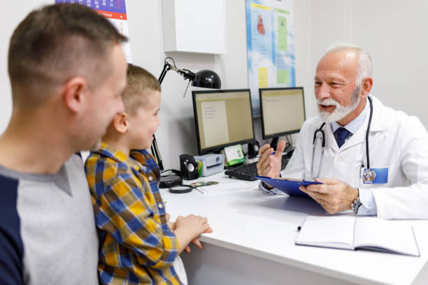 istock Little boy and his dad visiting pediatrician 1249749613