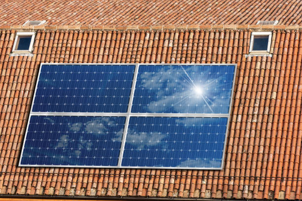 istock House Roof with Solar Panels - Renewable Energy 1249751132