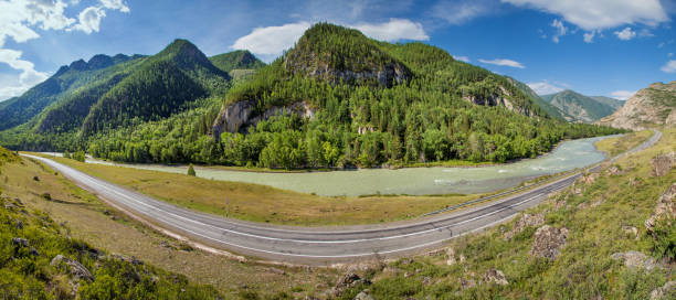istock Summer panoramic view. Asphalt road passes through the gorge along the river, Chuiski tract, Altay. 1249752795