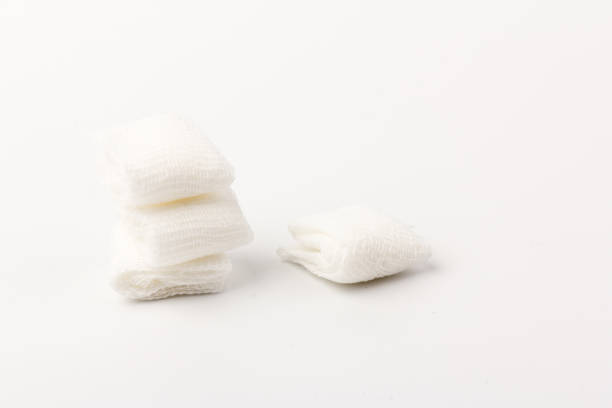 istock White gauze pads on white background. Materials for dental surgery. Close up 1249753224