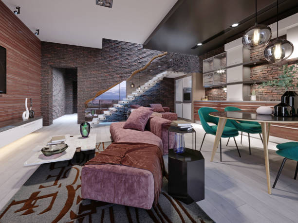 istock Studio loft design with staircase and dark brick wall. Living room with burgundy upholstered furniture and a modern kitchen. 1249753696