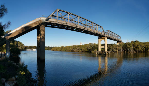 istock Pedestrian and water pipe bridge across a calm Parramatta river 1249754651