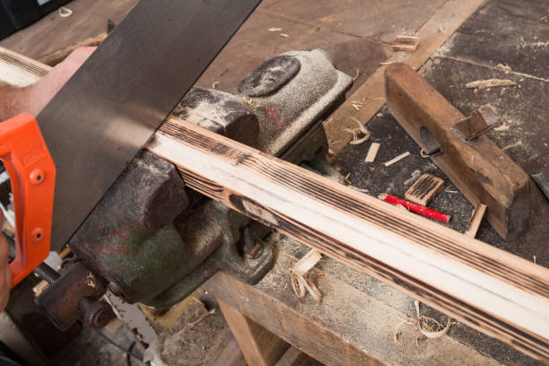 istock Male carpenter working on old wood in a retro vintage workshop. 1249754864