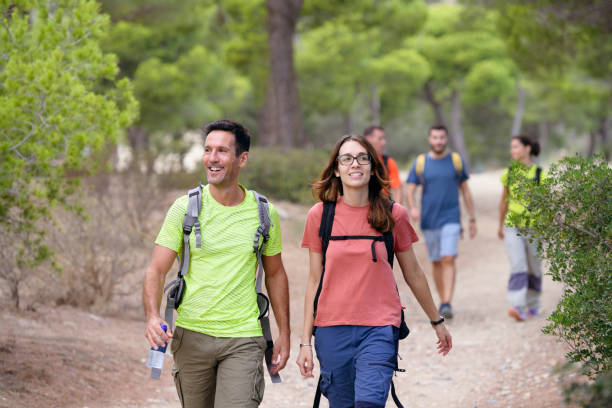 istock Hikers with backpacks leading the way on day hike 1249756221