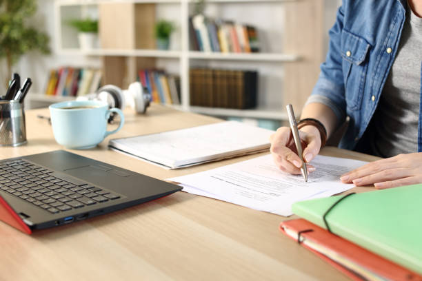 istock Student girl hands doing exam at home 1249756236