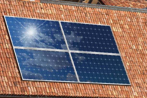 istock House Roof with Solar Panels - Renewable Energy 1249757055