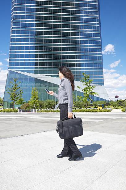 istock businesswoman with smartphone and briefcase 124975725