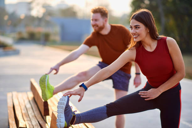 istock Sporty couple doing exercise in urban area during sunset / sunrise. 1249757726