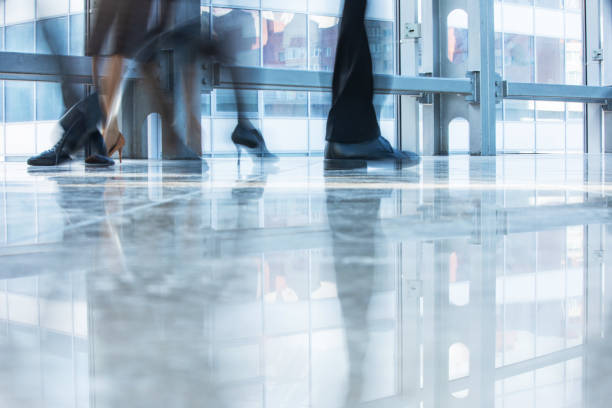 istock Blurred motion of people walking 1249758402