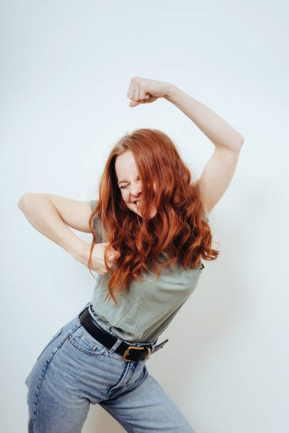 istock Young woman partying dancing with raised arms 1249758765