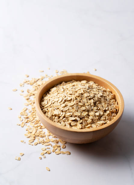 istock wooden bowl set against a marble backdrop with a copy area. 1249758785