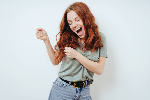 istock Happy young woman partying and dancing 1249759022