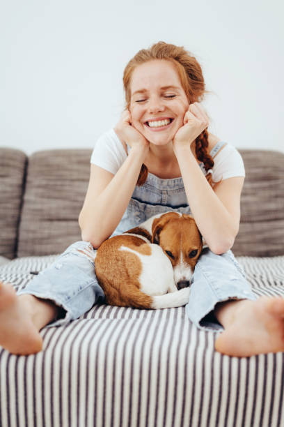 istock Cute young woman with her small dog 1249759116
