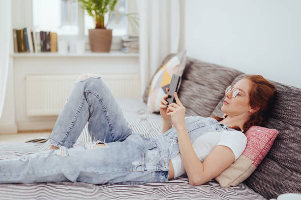 istock Trendy modern young woman relaxing on a day bed 1249759129