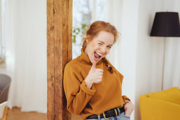 istock Cute playful young woman winking 1249759131