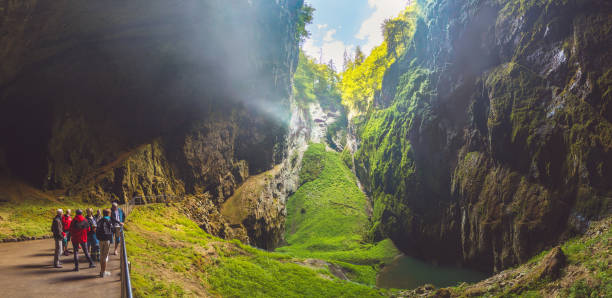 Macocha Gorge - The Macocha Abyss, Czech Republic Macocha Gorge - The Macocha Abyss (Propast Macocha). Sinkhole in the Moravian Karst Punkva caves system of the Czech Republic. People at the bottom of the abyss bottom the weaver stock pictures, royalty-free photos & images