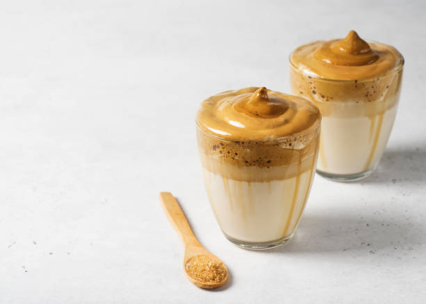 istock Korean dalgona coffee with brown foam in  glass close up on white background 1249759201