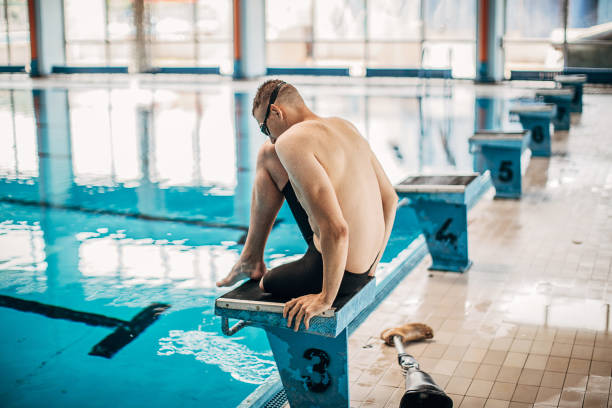 istock One man with disability preparing for jump in swimming pool 1249760696