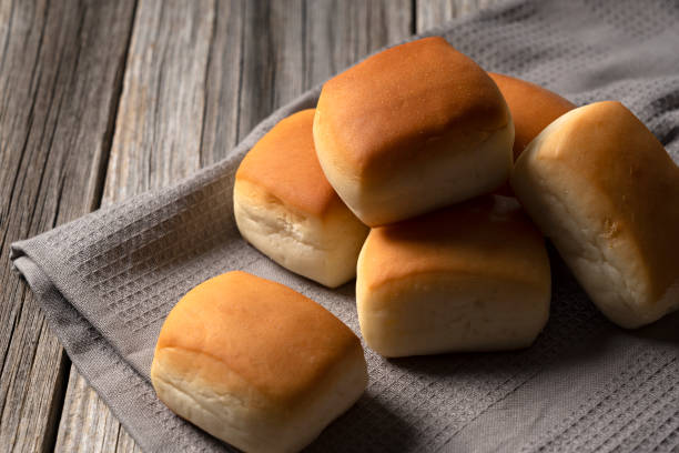istock Close up of a dinner roll pan placed against an old wooden backdrop 1249760782