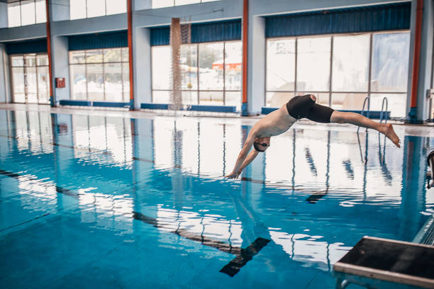 istock One man with disability jumping in swimming pool 1249760842