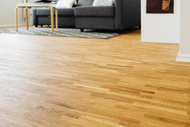 istock Light hardwood parquet floor in a living room 1249760863