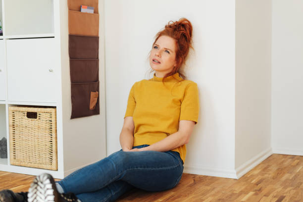 istock Young redhead woman sitting deep in thought 1249760986