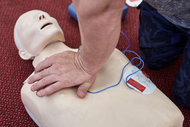 istock Male instructor teaching cardiopulmonary resuscitation with CPR dummy 1249760997