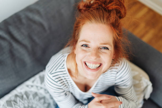 istock Cute mischievous young redhead woman grinning 1249761740