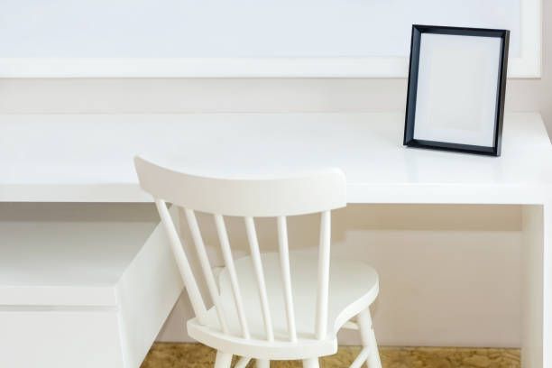 istock White table with chair and empty photo frame 1249763124