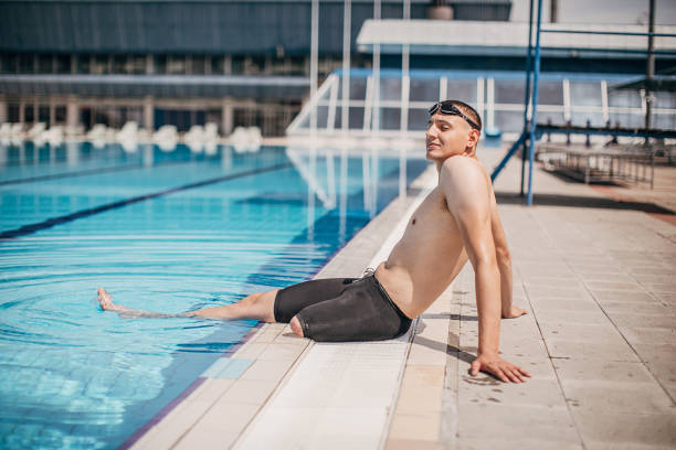 istock Man with disability relaxing on poolside at outdoor swimming pool 1249763586