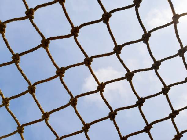 istock Football Goal Post Netting Against Blue Sky 1249763917