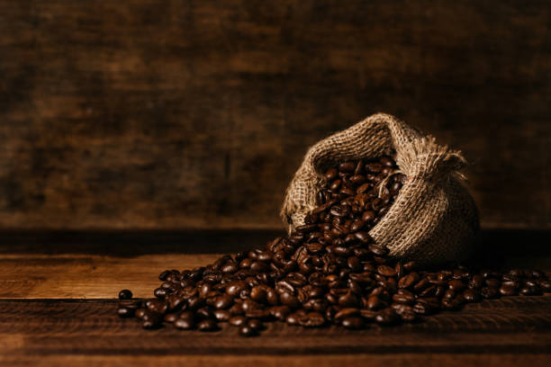 istock Fresh Roasted Coffee Beans With Burlap Sack On A Wooden Table 1249763975