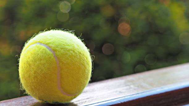 istock Tennis ball on Black background. 1249764196
