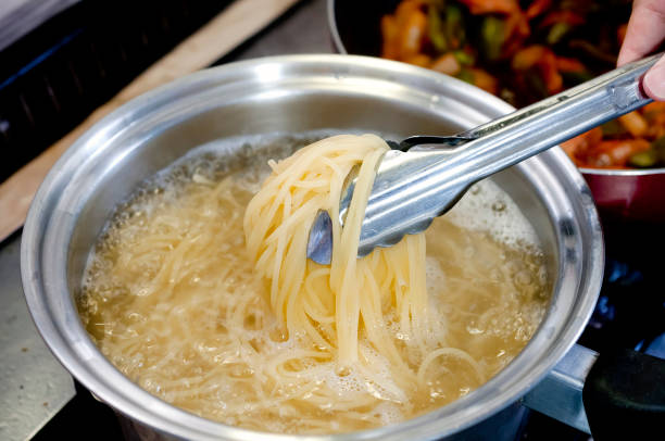 istock Pasta boiling in a pot with tongs 1249767791