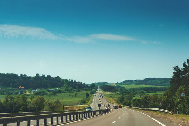 istock Traffic in high speed on a highway through summer landscape. 1249768597