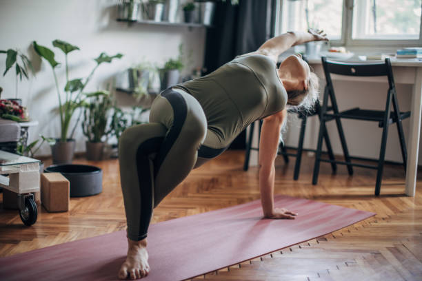 istock Woman practice yoga at home 1249768981