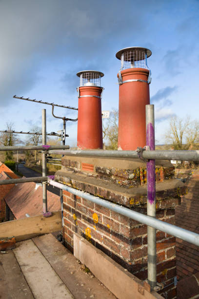 istock Chimney pots and scaffolding, roof repairs, UK 1249769097