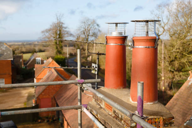 istock Clay chimney pot with cowl on a roof in UK 1249769159
