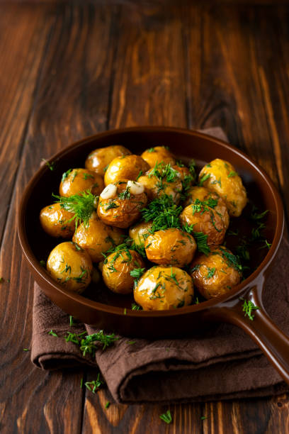 istock Oven-baked potatoes with garlic and herbs 1249769189
