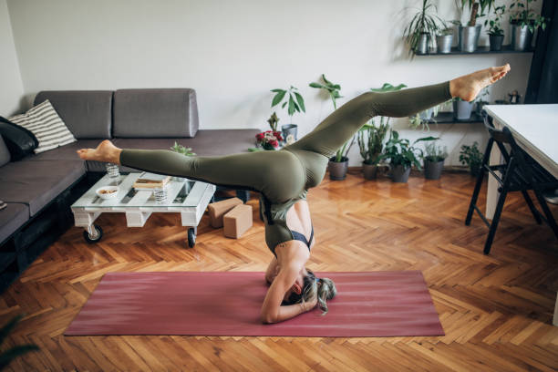 istock Woman in headstand pose 1249769278