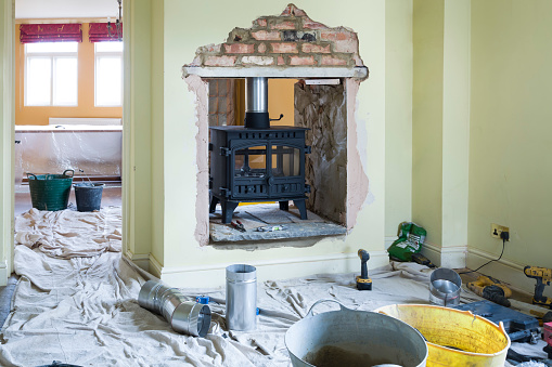 Installing a double-sided wood burning stove during a UK home improvement project
