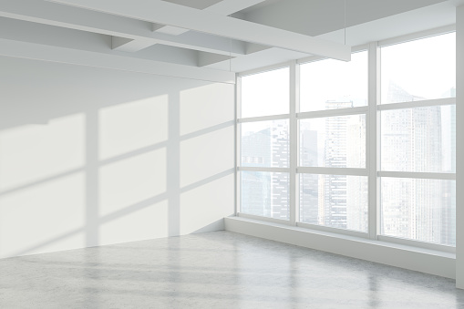 Empty white wall in panoramic industrial style office corner with concrete floor and window with blurry cityscape. Concept of real estate. 3d rendering
