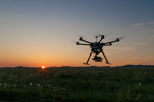 Fawn rescue with new technology in Bavaria , Germany. Fawn rescue with thermal imaging drone in Bavaria at sunrise.