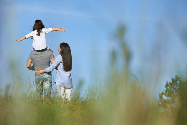 istock happy family having fun and playing in nature. 1249772281