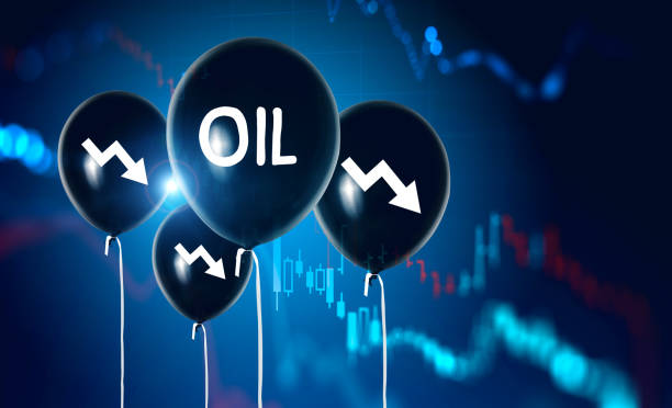 istock Oil balloons and falling graphs on blue 1249772589